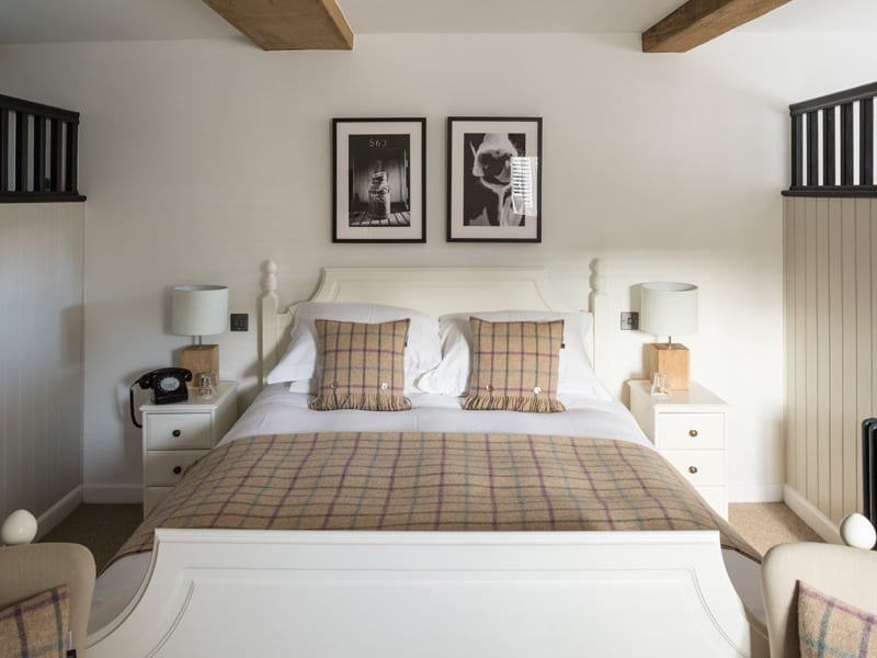 Bed in a Suite at the Tudor Farmhouse Hotel