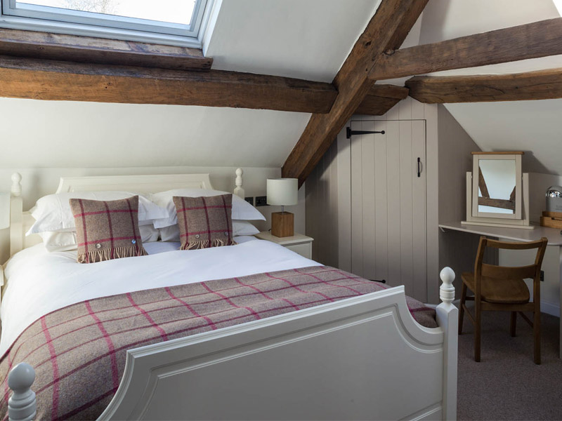 Bedroom in a Suite at the Tudor Farmhouse Hotel